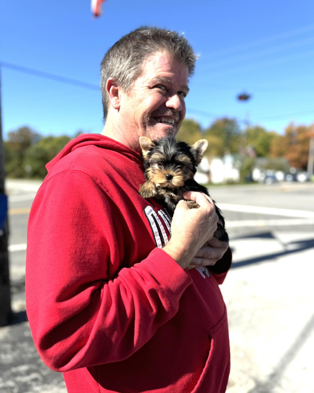 Happy family with their Yorkie puppy